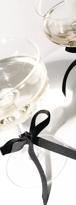 Champagne coupe with a black ribbon