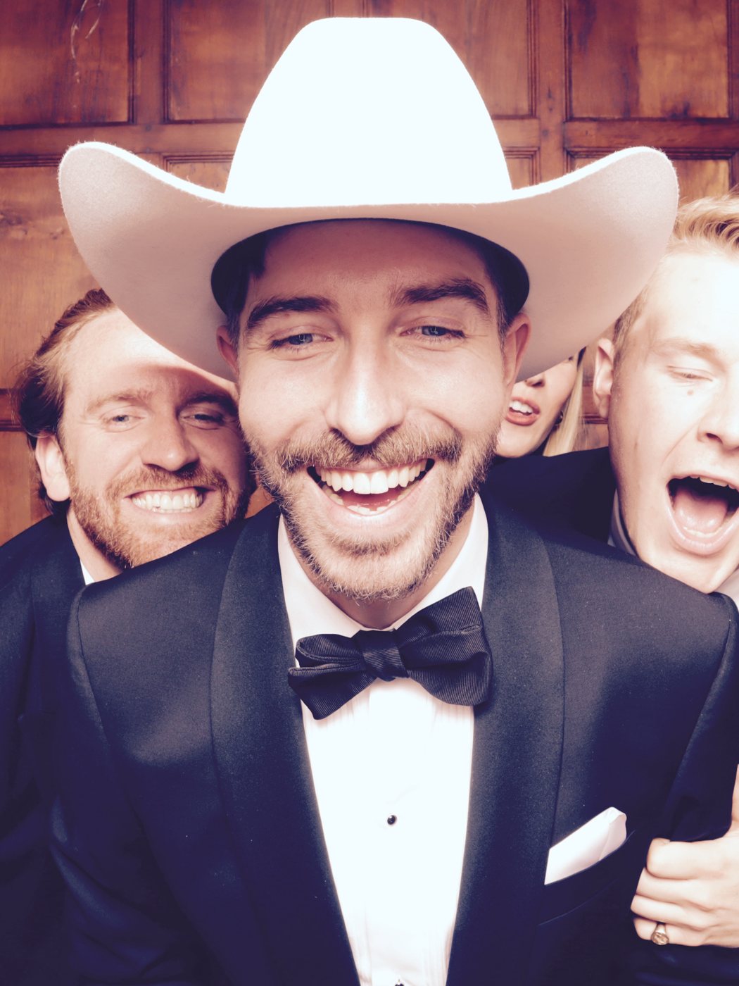Guests in the photo booth at the wedding of Paige & Richard